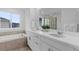 Bright bathroom with double vanity, quartz countertops, and soaking tub and shower at 13446 Amber Sky St, Parker, CO 80134