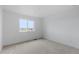 Empty bedroom with carpet, a large window with mountain views, and neutral tones, offering a versatile living space at 13446 Amber Sky St, Parker, CO 80134