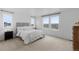 Serene bedroom with a large bed, neutral decor, and expansive windows offering scenic views at 13446 Amber Sky St, Parker, CO 80134