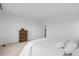 Minimalist bedroom showcasing a dresser and a comfortable bed with white linens, creating a serene and uncluttered space at 13446 Amber Sky St, Parker, CO 80134