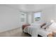 Bright bedroom with neutral tones, carpet floors, and two large windows providing natural light at 13446 Amber Sky St, Parker, CO 80134