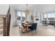 Dining area features a wooden table, bench, and blue chairs near a cozy fireplace at 13446 Amber Sky St, Parker, CO 80134