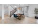 Stylish dining room with wooden table, pendant lighting, and staircase at 13446 Amber Sky St, Parker, CO 80134