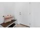 Welcoming entryway features a bench with decorative pillows next to a white door at 13446 Amber Sky St, Parker, CO 80134