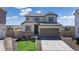 Beautiful two-story home with a two-car garage, manicured lawn, and neutral color palette at 13446 Amber Sky St, Parker, CO 80134