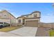 Two-story home showcasing neutral siding, a two-car garage, and professional landscaping at 13446 Amber Sky St, Parker, CO 80134