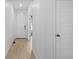 Bright hallway with light wood floors and white doors, offers a clean, modern aesthetic at 13446 Amber Sky St, Parker, CO 80134