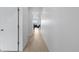 Bright hallway with wood floors, white walls, and access to the main living area at 13446 Amber Sky St, Parker, CO 80134