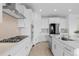 Bright kitchen with stainless steel appliances, quartz countertops, modern lighting, and a gas range at 13446 Amber Sky St, Parker, CO 80134