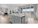 Bright, open kitchen featuring a large island, stainless steel appliances, and sliding glass doors to the backyard at 13446 Amber Sky St, Parker, CO 80134