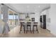 Modern kitchen boasts stainless steel appliances, an island with bar seating, and sliding glass door access to the backyard at 13446 Amber Sky St, Parker, CO 80134