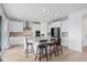 Modern kitchen boasts white cabinetry, stainless steel appliances, and a large center island with seating at 13446 Amber Sky St, Parker, CO 80134
