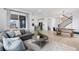 Open-concept area with living room, kitchen, dining and staircase bathed in light at 13446 Amber Sky St, Parker, CO 80134