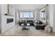 Bright living room with large windows, fireplace, and comfortable seating area at 13446 Amber Sky St, Parker, CO 80134
