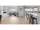Open-concept living room with a gas fireplace, view windows, and a large kitchen island with seating at 13446 Amber Sky St, Parker, CO 80134