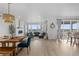 Open-concept living and dining area with a fireplace, natural light, and modern furnishings at 13446 Amber Sky St, Parker, CO 80134