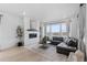 Cozy living room boasts a modern fireplace, large windows, and comfortable seating area with neutral decor at 13446 Amber Sky St, Parker, CO 80134