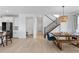 Spacious living space featuring an open floor plan, seamlessly connecting the dining area to the kitchen and stairs at 13446 Amber Sky St, Parker, CO 80134