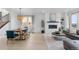 Open-concept living space featuring a fireplace, neutral walls, and dining area with natural light at 13446 Amber Sky St, Parker, CO 80134