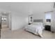 Main bedroom showcasing a neutral color palette, large windows, and carpet flooring at 13446 Amber Sky St, Parker, CO 80134