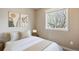 Well-lit bedroom features a comfortable bed, neutral decor, and a bright window view at 1095 W 69Th Ave, Denver, CO 80221
