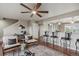 A living room with hardwood floors, a ceiling fan, and a seating area at 1095 W 69Th Ave, Denver, CO 80221