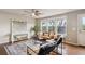 A living room with hardwood floors, a ceiling fan, and large windows at 1095 W 69Th Ave, Denver, CO 80221