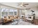 A living room with hardwood floors, a ceiling fan, and large windows at 1095 W 69Th Ave, Denver, CO 80221