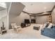 Finished basement featuring a fireplace, living area with TV, and stairs to the upper level at 519 S Gaylord St, Denver, CO 80209