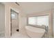 Elegant bathroom featuring a standalone tub and a large window at 519 S Gaylord St, Denver, CO 80209
