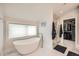 Bright bathroom with a standalone tub, modern fixtures, and access to a walk-in shower at 519 S Gaylord St, Denver, CO 80209