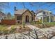 Craftsman-style home with stone facade, brick accents, and professionally landscaped front yard at 519 S Gaylord St, Denver, CO 80209