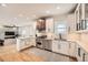 Bright kitchen with stainless steel appliances, white cabinetry, and stylish copper range hood at 519 S Gaylord St, Denver, CO 80209