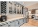 Kitchen counter and cabinets adjacent to stainless steel refrigerator and wine rack storage at 519 S Gaylord St, Denver, CO 80209