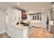 Well-lit kitchen with stainless steel appliances, quartz countertops and white cabinets at 519 S Gaylord St, Denver, CO 80209