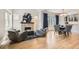 Inviting living room with stone fireplace, blue accents, hardwood floors, and a dining area to the rear at 519 S Gaylord St, Denver, CO 80209