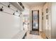Welcoming mudroom featuring a bench, coat rack, and storage cabinets with hardware and hardwood flooring at 519 S Gaylord St, Denver, CO 80209