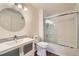 Updated bathroom with modern vanity, round mirror, and tiled shower with glass doors at 3250 E 103Rd Pl # 805, Thornton, CO 80229