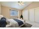 Bedroom featuring a double bed, window and two closets. Neutral wall tone at 3250 E 103Rd Pl # 805, Thornton, CO 80229