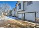 Exterior view of townhomes featuring attached garages and well-maintained landscaping at 3250 E 103Rd Pl # 805, Thornton, CO 80229
