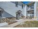 Charming townhome exterior showcasing a stone facade, gray siding, and well-kept landscaping at 3250 E 103Rd Pl # 805, Thornton, CO 80229