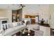 Open-concept living room flows into the kitchen with bar seating, fireplace and a ceiling fan at 3250 E 103Rd Pl # 805, Thornton, CO 80229