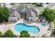 Aerial view of a large, kidney-shaped community pool with a hot tub and ample lounge seating for residents and guests at 3250 E 103Rd Pl # 805, Thornton, CO 80229