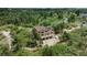 Aerial view of a house with solar panels surrounded by lush trees at 8403 Homestake Ct, Larkspur, CO 80118