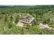 Aerial view of the home in a lush green forest setting at 8403 Homestake Ct, Larkspur, CO 80118