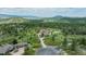 Gorgeous home surrounded by lush trees with a long driveway leading to the house at 8403 Homestake Ct, Larkspur, CO 80118