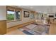 Finished basement featuring wood floors, a large area rug, and natural light at 8403 Homestake Ct, Larkspur, CO 80118