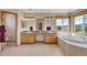 Bright bathroom with double vanities, a soaking tub under a window, and a separate shower at 8403 Homestake Ct, Larkspur, CO 80118