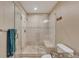 Clean and modern bathroom featuring a glass shower and tiled walls at 8403 Homestake Ct, Larkspur, CO 80118