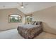 Bedroom featuring large windows, vaulted ceilings, and comfortable bedding at 8403 Homestake Ct, Larkspur, CO 80118